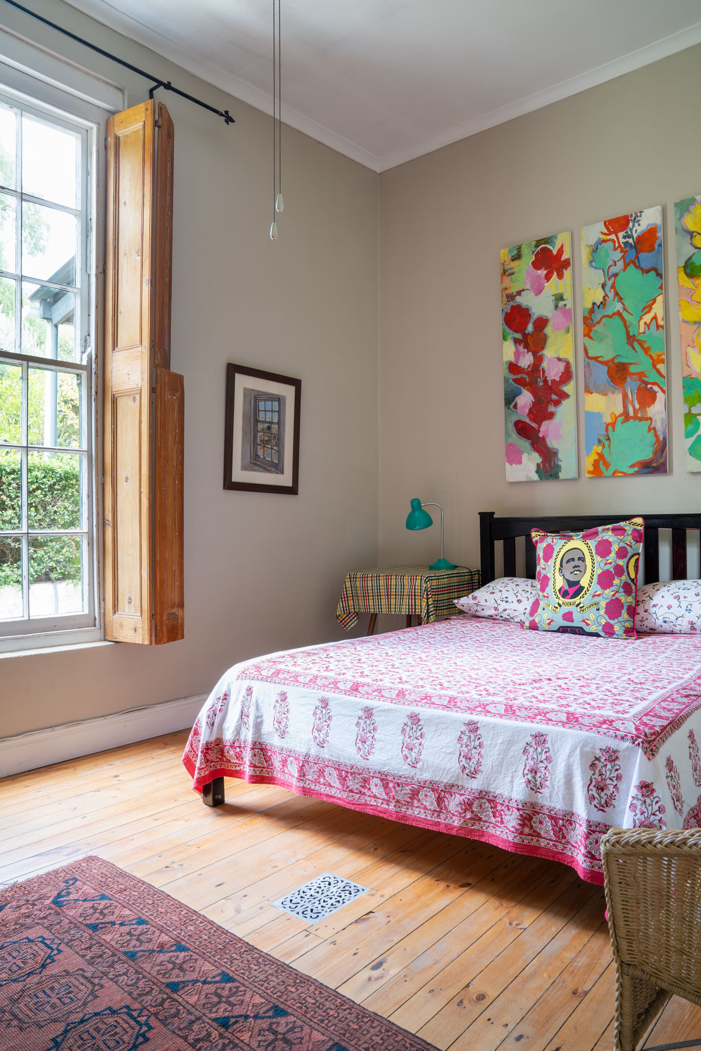 Colourful bedroom with a mix of bold patterns and graphic, illustrative fabrics